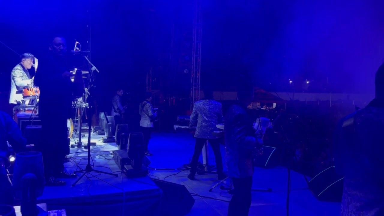 Grupo musical en vivo sobre el escenario con iluminación azul